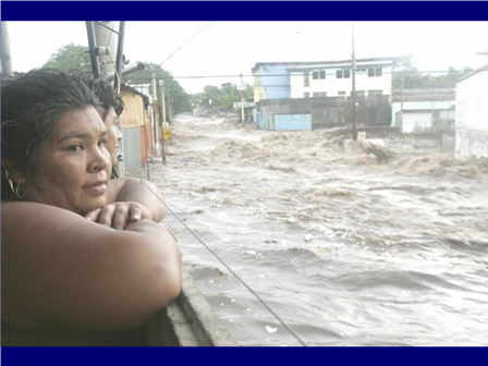 Photo of woman watching the flood waters rise in Guatemala.