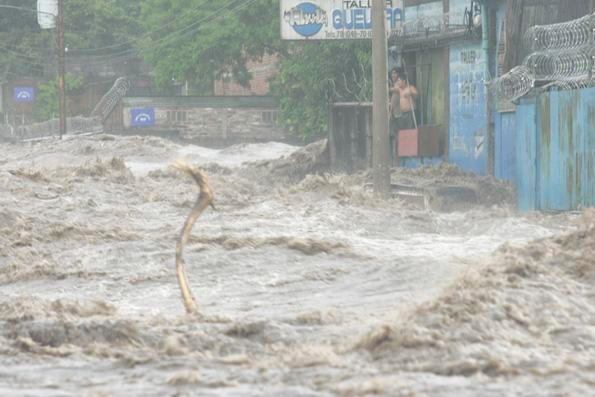 Water surging down the street of small village.