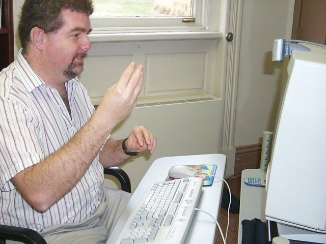 Photo of a man involved in a video call on a PC.