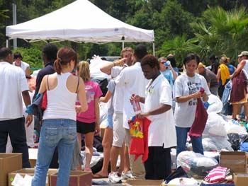 Photo of people looking at donations of clothing.