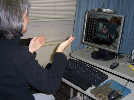 Image of a woman chatting with someone using video relay.