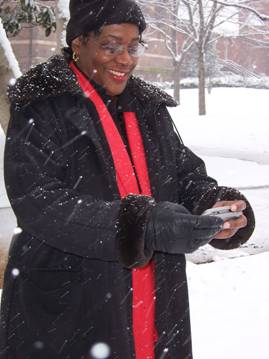 Image of a woman checking her Sidekick while standing outside in the snow.