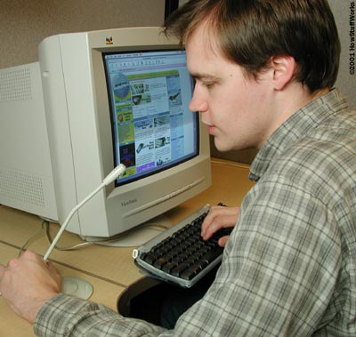 Image of a man speaking into a microphone connected to his PC.