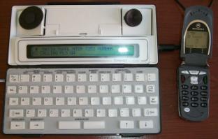 Image of an Ultratec Compact-C TTY with a Motorola V60t wireless handset.